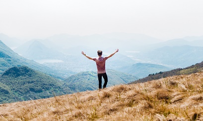 man worshiping in the mountains